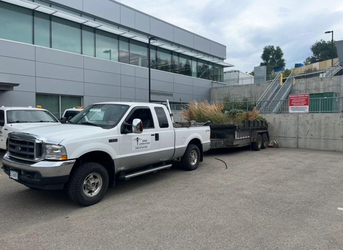 gaia landscaping truck and trailer working on site
